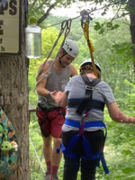 camper and counselor on ropes course