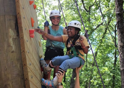 camper and counselor on rock wall